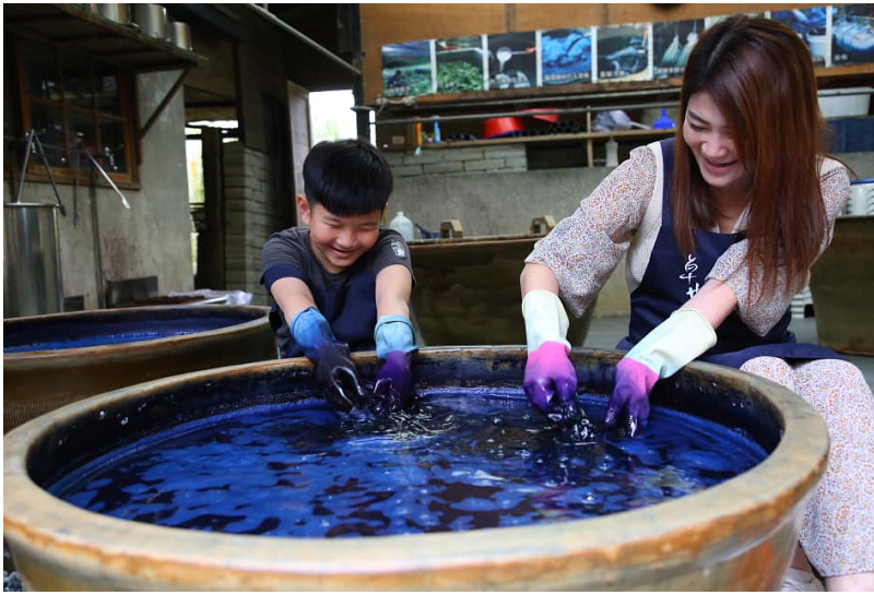 the fabric undergoes three cycles of immersion and rinsing in the indigo dye vats