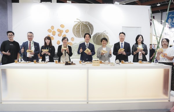 圖1 賴總統在古主委陪同下特別蒞臨客家主題館，品嘗融合傳統與創新的小點—覆菜可麗露、客家桔醬滷味，以及貓裏紅茶福福